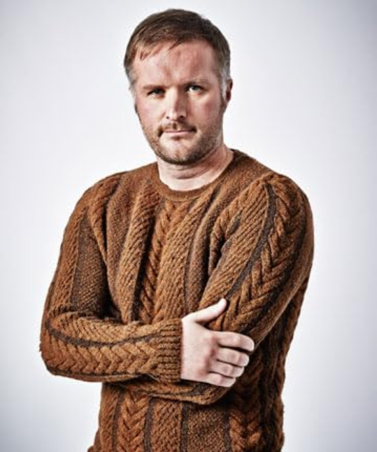 A picture of Stu Rutherford, a man with dark blond hair and short blond beard. Picture taken from:https://www.imdb.com/name/nm2975042/?ref_=tt_cl_i_5