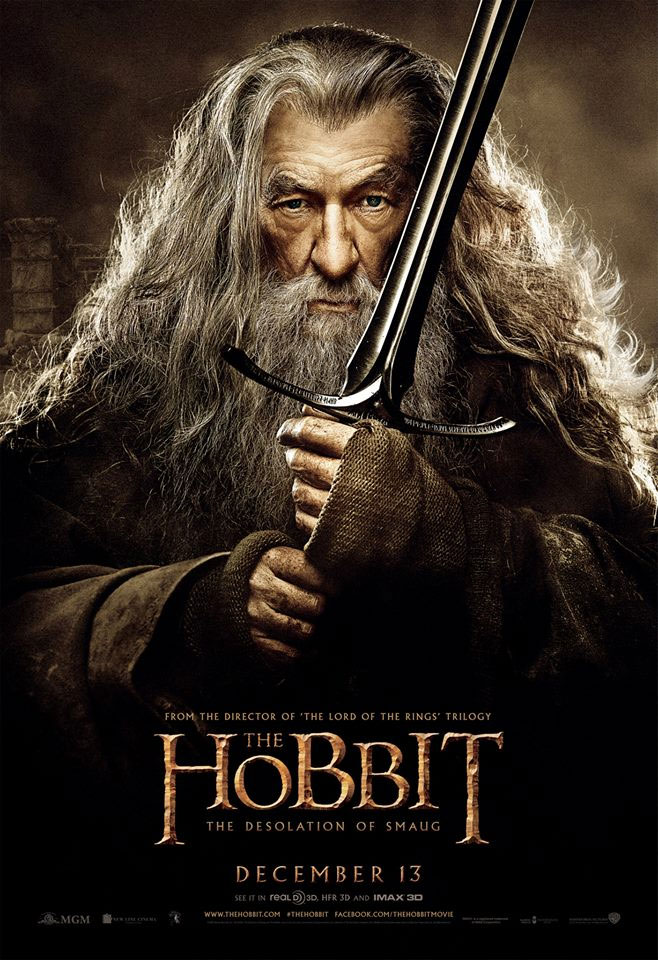 A movie poster for the Hobbit - The Desolation of Smaug, a old looking man with a long grey beard and long grey hair holding a sword.