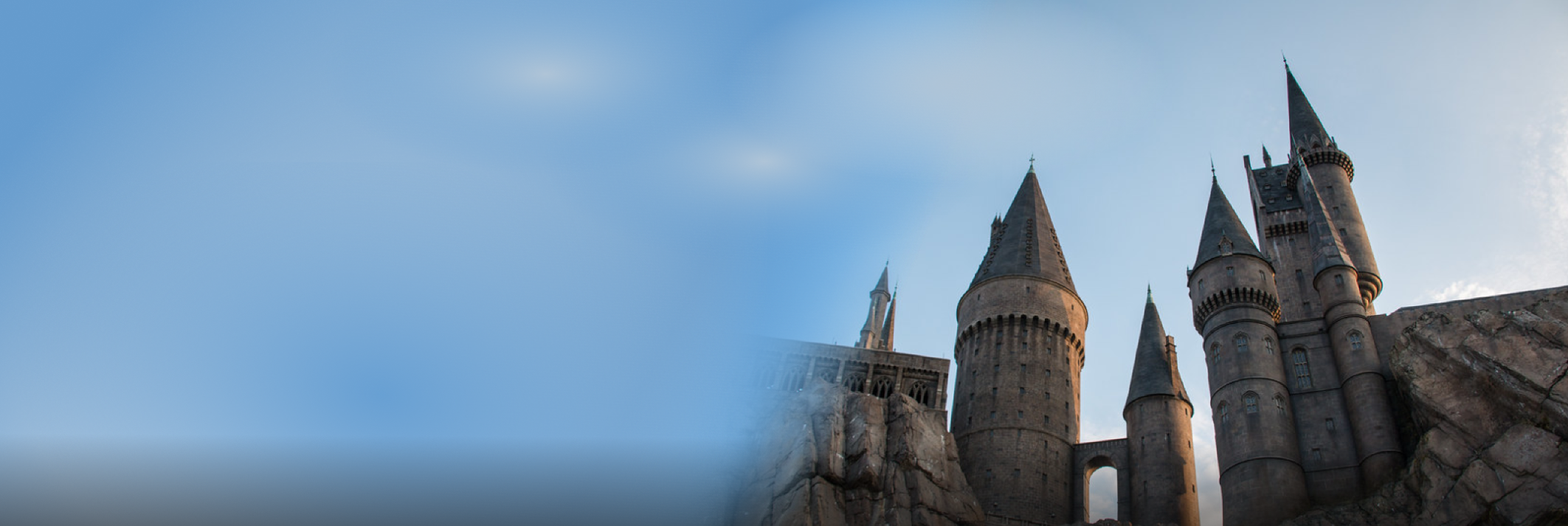 A stone Castle called Hogwarts, with a bright blue sky in the background
